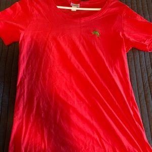 Coral tee with green iguana logo